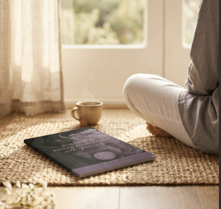 A peaceful lifestyle image featuring the Building a Kinder Relationship with Yourself self-compassion workbook by My Calm Hour beside a cup of tea, representing gentle journaling, emotional healing, and intentional self-care.